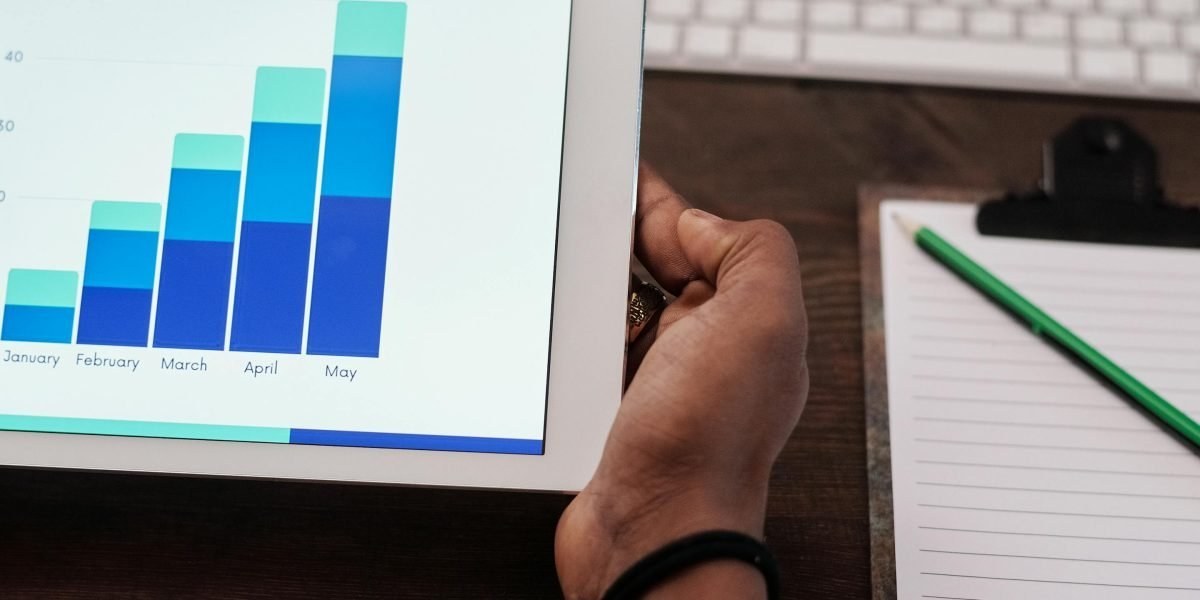 Notepad and tablet showing health tech analytics and charts