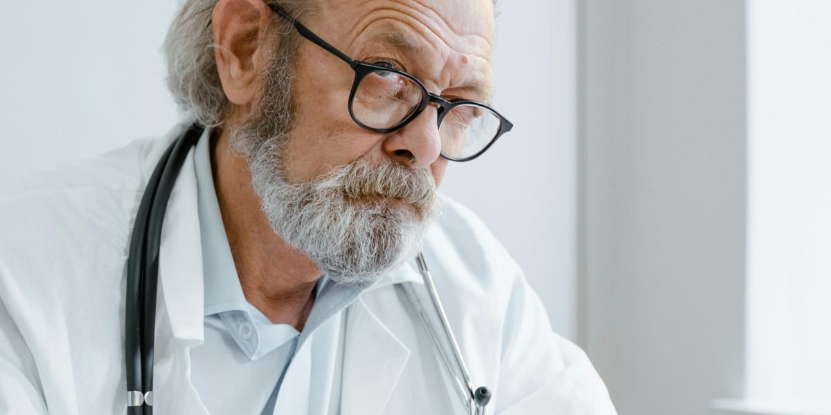 An elderly person comfortably engaging in a telehealth consultation with a healthcare professional from their home.