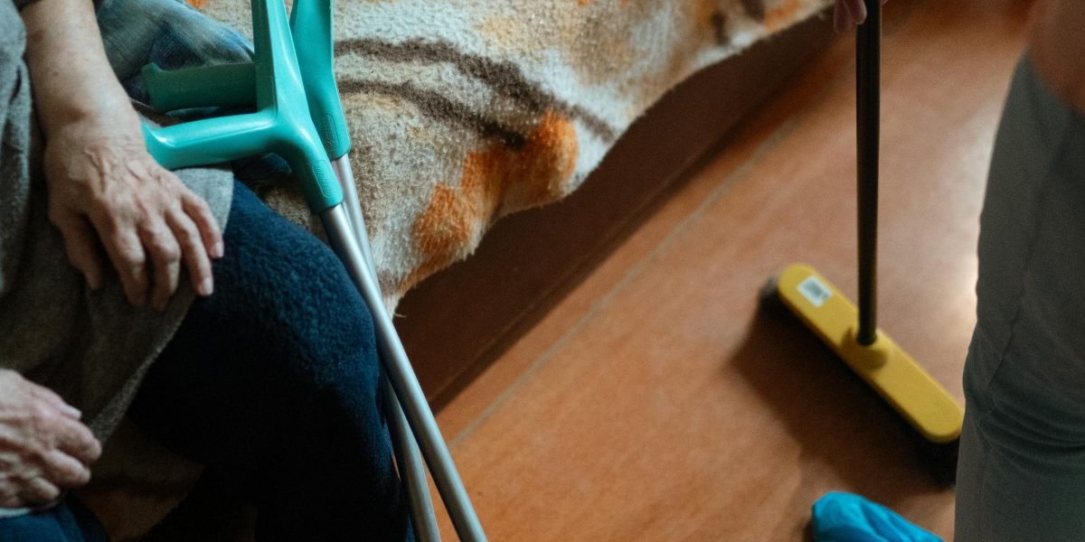 A caring interaction between a caregiver and an elderly person with dementia in a home setting, fostering comfort and safety.