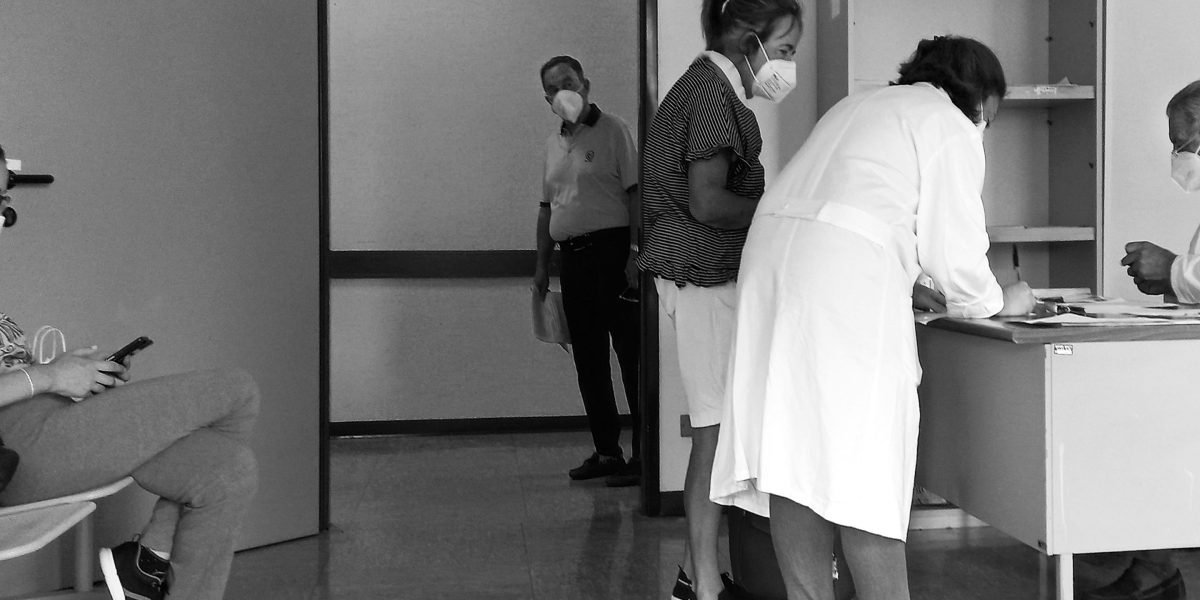 A bustling family health center waiting room, reflecting the high patient demand and workload faced by clinics.
