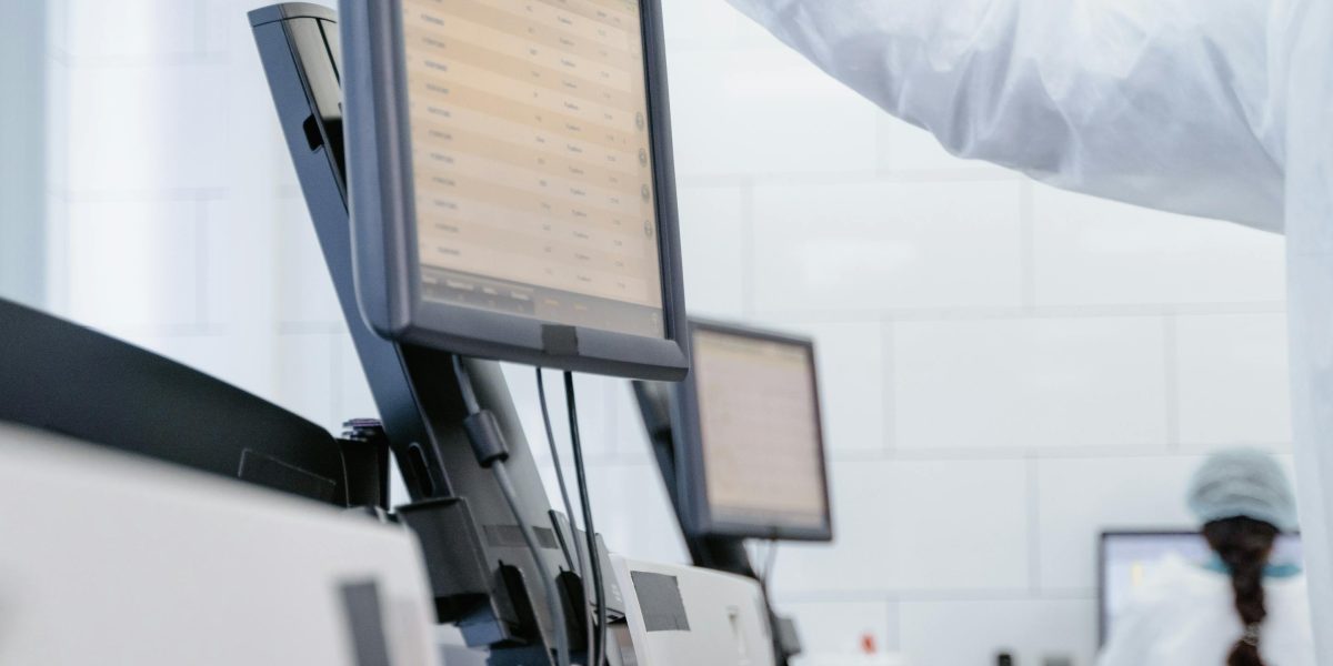 A healthcare professional thoughtfully reviews patient data on a tablet, symbolizing informed decision-making and real-time care coordination.
