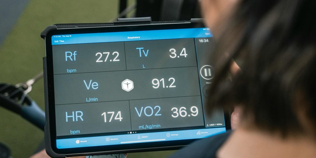 A patient comfortably at home, interacting with a remote health monitoring device.