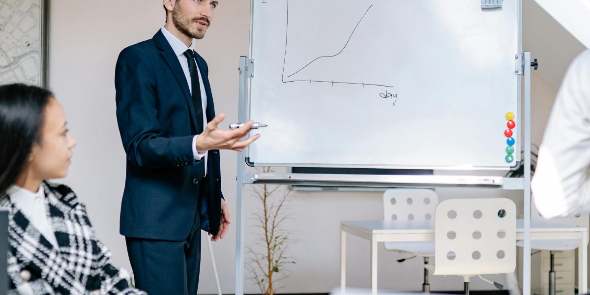 A project manager clearly outlining an implementation roadmap to a team in a meeting setting.
