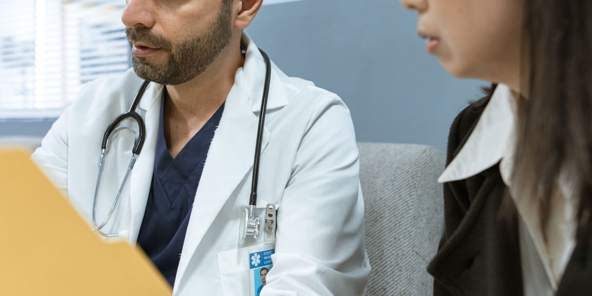 A doctor empathetically engaging with a patient, reflecting improved care experiences.