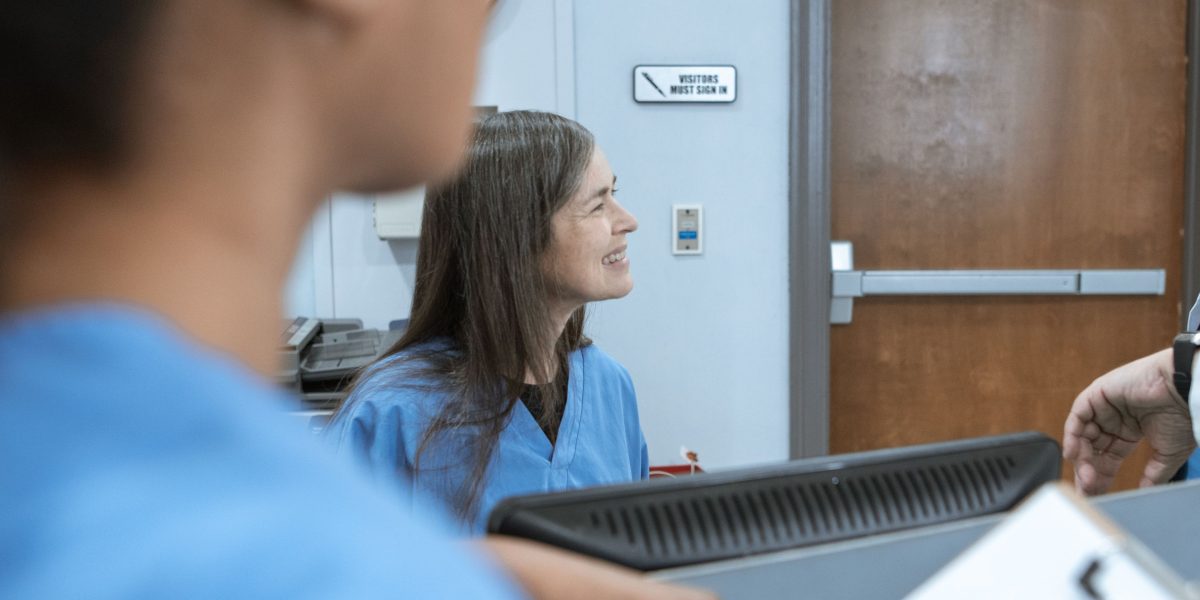 A diverse healthcare team collaborating in a busy hospital environment, emphasizing clear communication.
