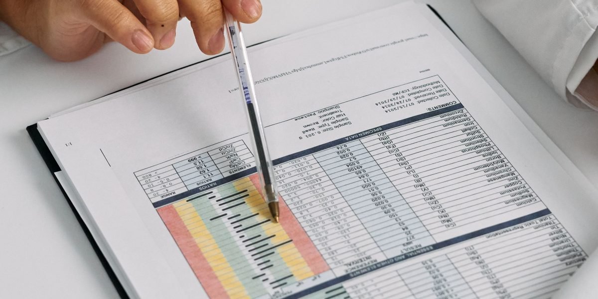 A medical professional carefully reviewing a patient's chart, indicating the need for precision and understanding in medical documentation.