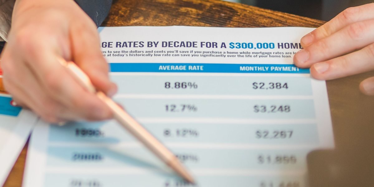 An individual carefully comparing different Medicare Part D plan options laid out on a table.