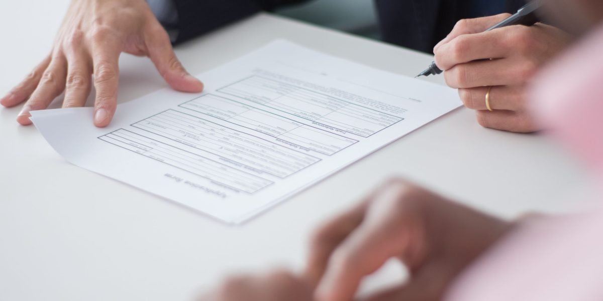 Business professionals engaged in a serious negotiation, representing the complexities of regulatory approval and reimbursement pathways.
