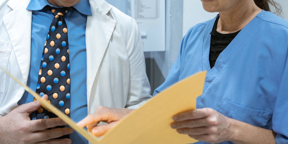 A hospital committee carefully reviewing documents and data to make informed decisions about new medical device procurement.