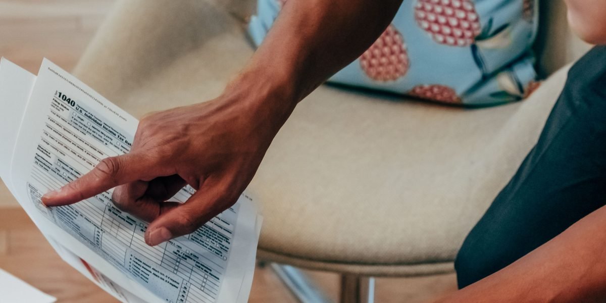 A person thoughtfully examines various health insurance plan options, reflecting the consumer's decision-making process.