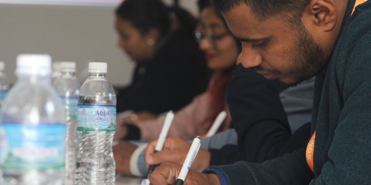 University leaders in a discussion, symbolizing strategic decision-making for student health coverage.