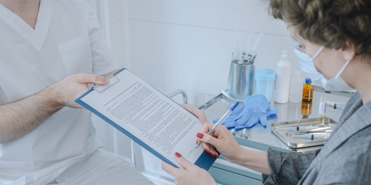 A healthcare professional reviews patient information on a digital health system, ensuring accuracy.