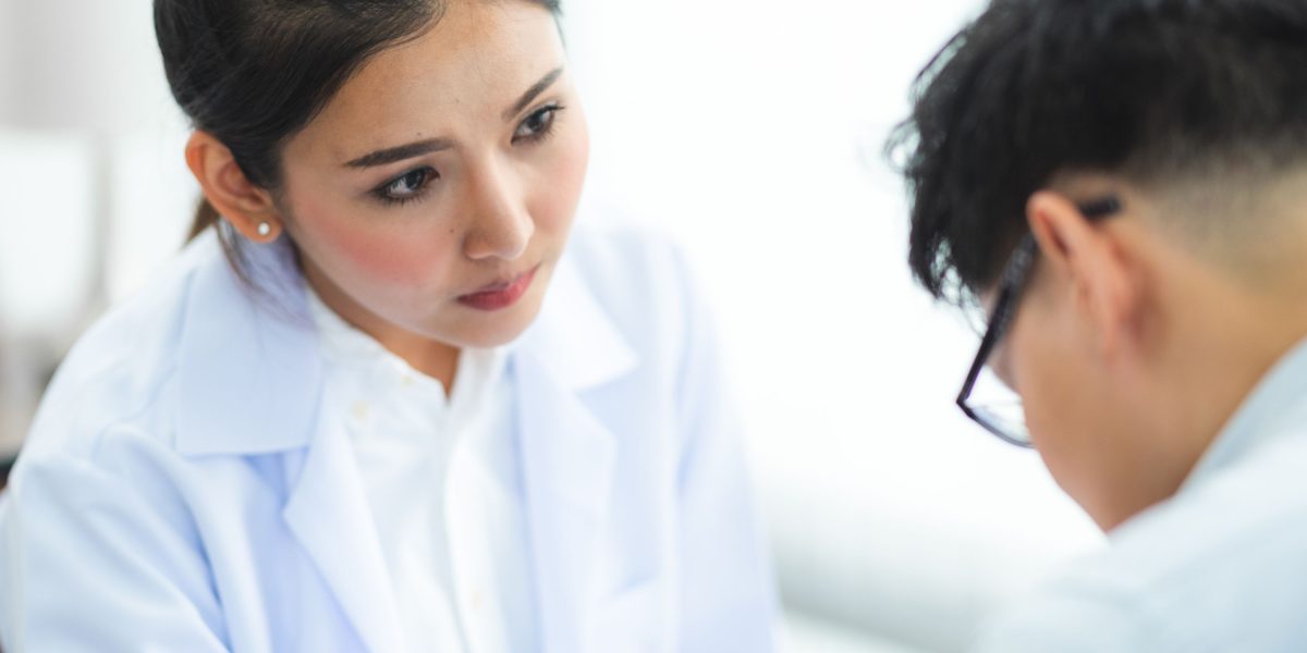 A doctor and patient engaging in a serious conversation, highlighting the human impact of medical errors and the need for clear communication.