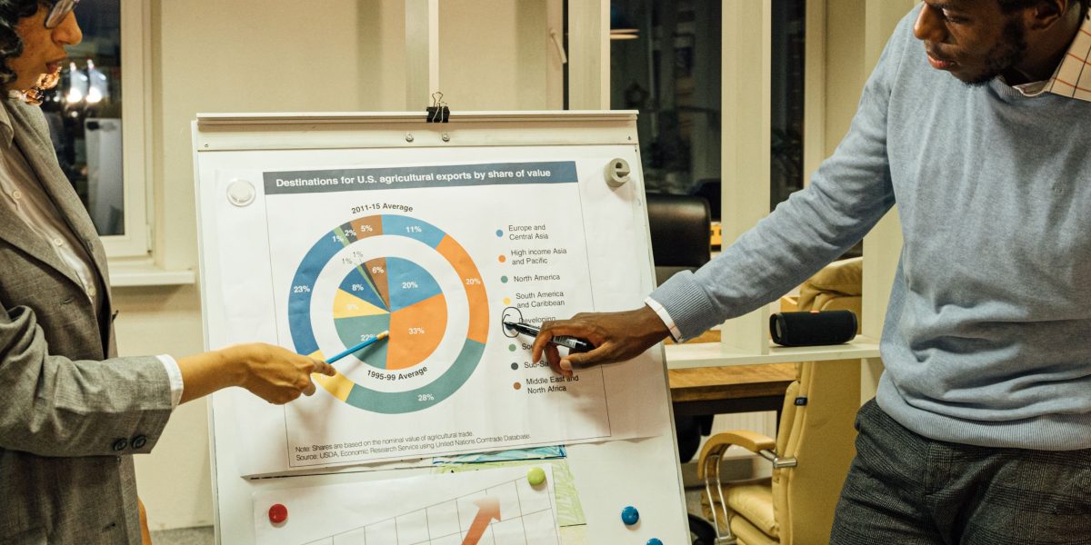Team members actively collaborate and clarify concepts on a whiteboard during a project meeting.