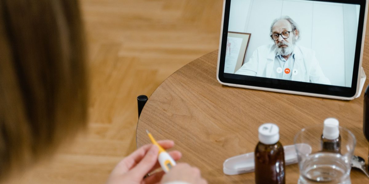 A person engaging in a video call with a healthcare professional, representing modern telehealth.