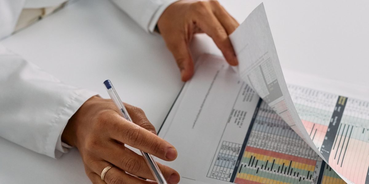 A healthcare professional appears concerned while reviewing patient notes, highlighting the impact of ambiguous abbreviations.