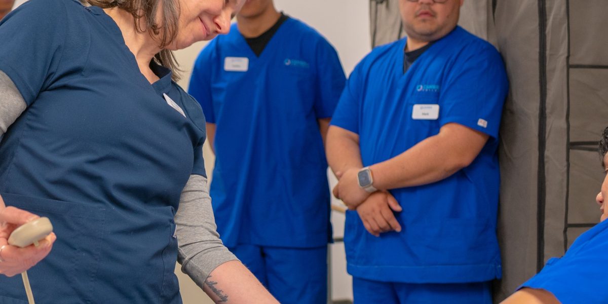 A healthcare professional leads a training session, educating staff on updated policies for medical abbreviation usage.