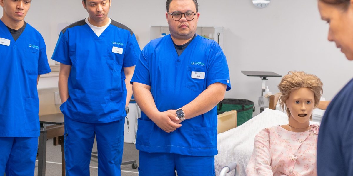 Healthcare professionals engaged in training to adapt to new digital tools and updated workflows within a hospital setting.
