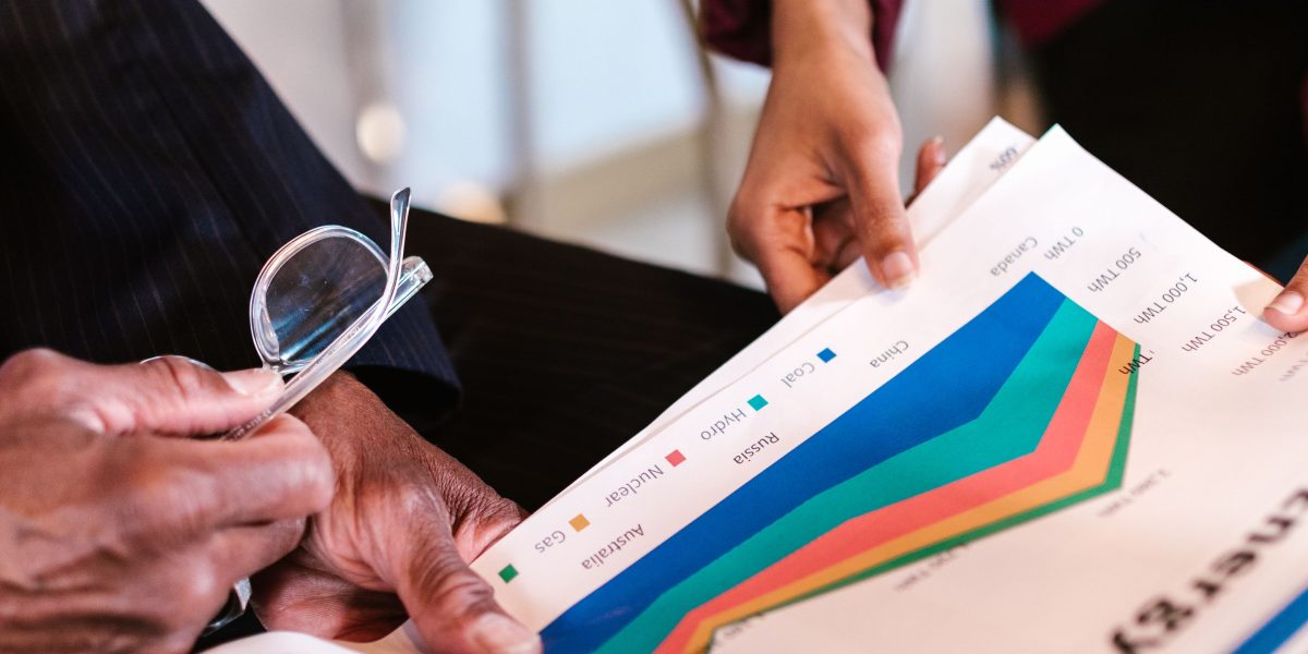 A team of professionals meticulously reviewing financial reports and data to make informed budgeting and investment decisions for new technology.