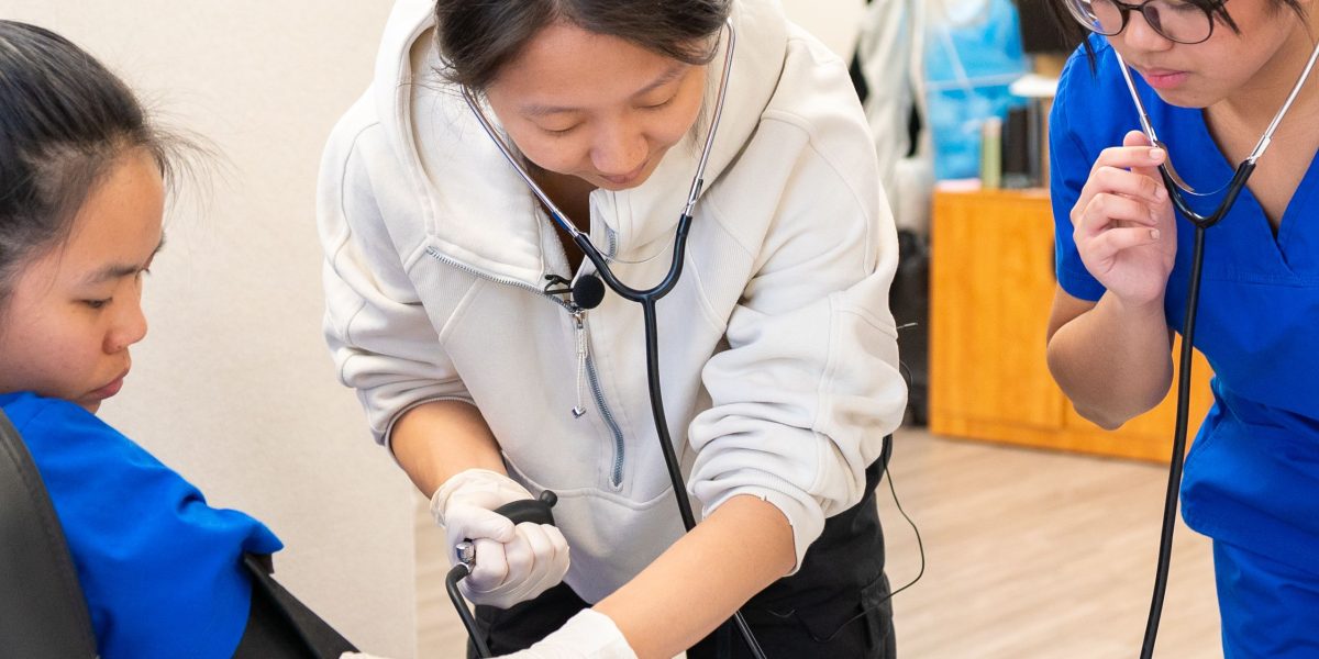 Nursing students in a simulation lab, practicing hands-on patient care skills essential for their training.