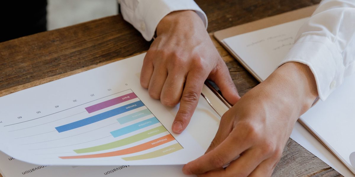 A business leader thoughtfully reviewing documents, making decisions about long-term investments.