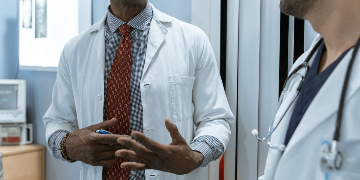 Healthcare providers engaged in a serious discussion, highlighting the gravity of clinical decisions and patient outcomes.